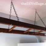 Antique ladder doubles as a drying rack for a laundry room. This is awesome!