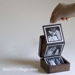 Box with tri-fold pictures that pull out with ribbon