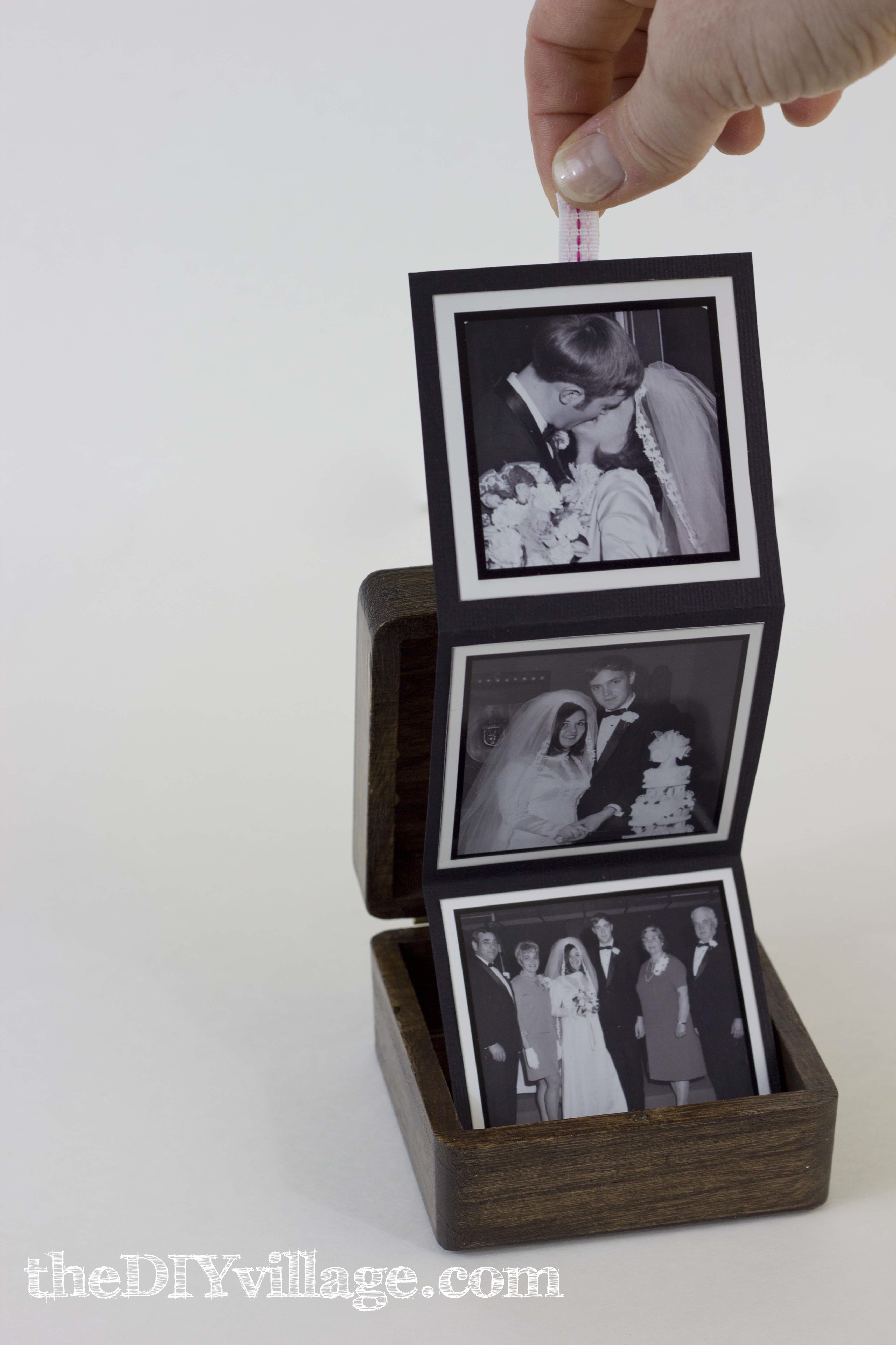 Box with tri-fold pictures that pull out with ribbon