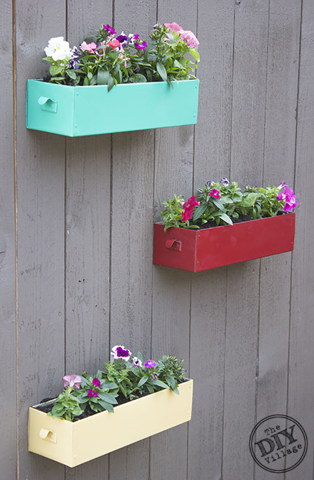 DIY Living Wall for your garden can be enjoyable year round depending on the types of plants that you use in the containers.