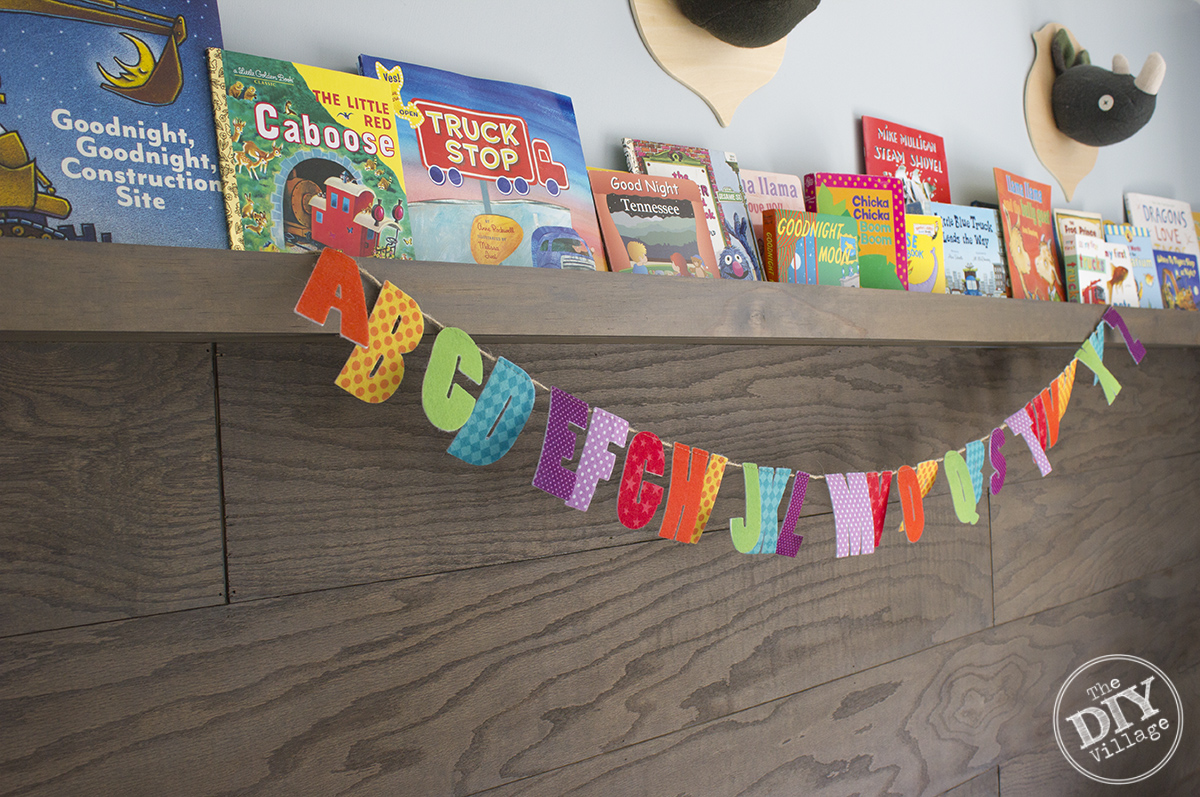 Modern Rustic baby nursery with bright pops of color and custom book ledge