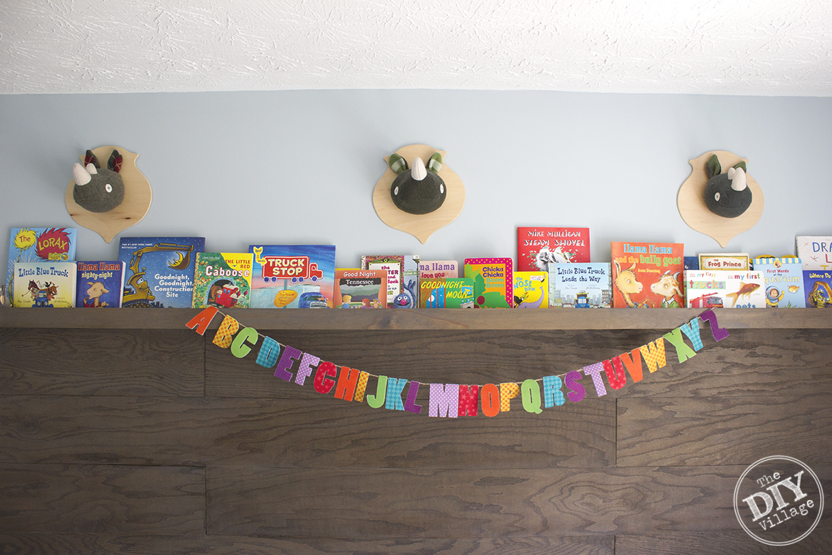 Modern Rustic baby nursery with bright pops of color and custom book ledge