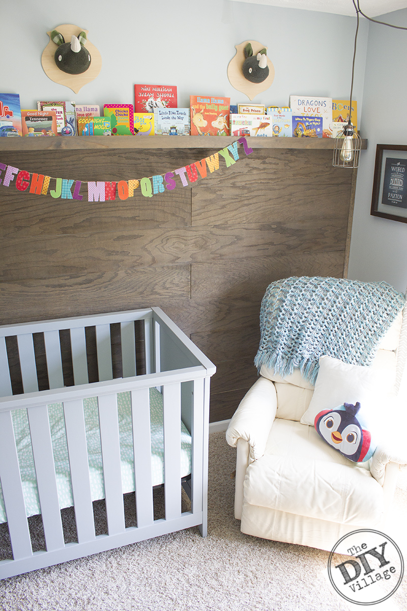 Modern Rustic baby nursery with bright pops of color and custom book ledge