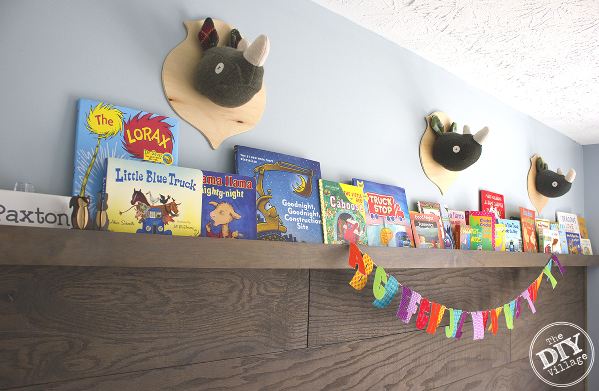 Modern Rustic baby nursery with bright pops of color and custom book ledge