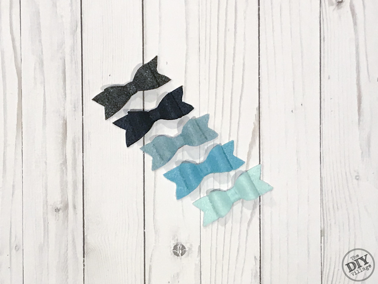 Small felt bows in shades of blues and grays