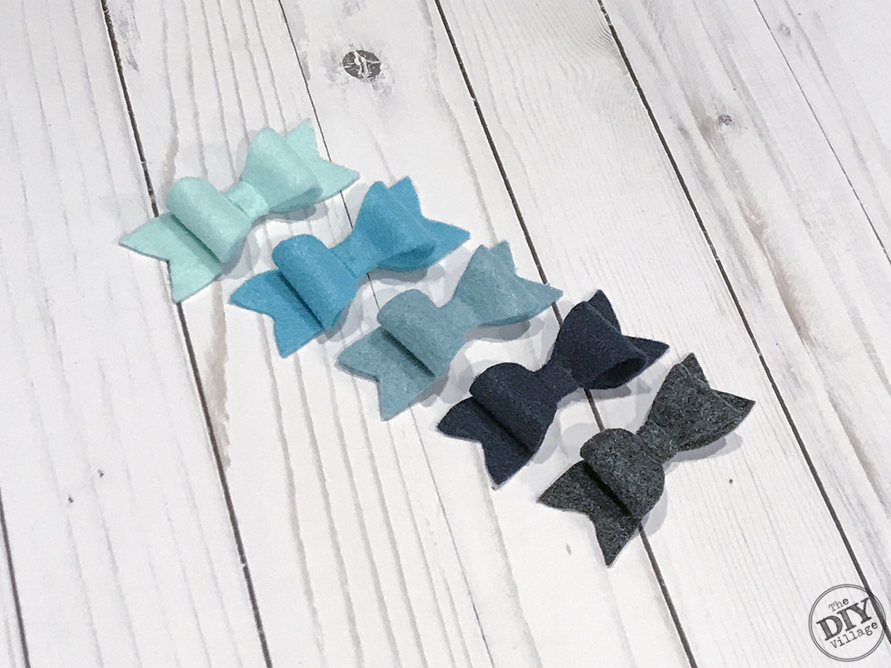 Small felt bows in shades of blues and grays