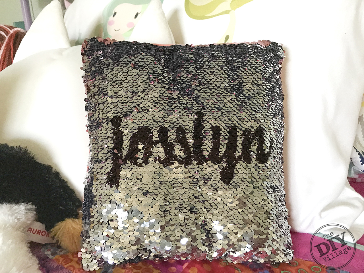 Easy Dollar Store Project - DIY Hidden Message sequin Pillow. They can be personalized with names, messages, anything! Such a fun idea. #hiddenmessagepillow #diycraft #sequinpillow #personalizedgift #monogrmamedgift #bling #sparkle #dollarstorecraft #dollarstorechallenge #fastcraft