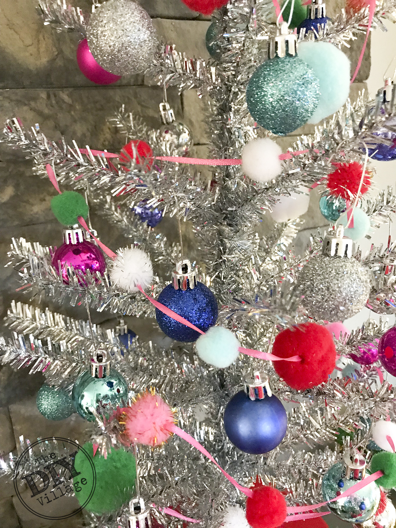 Easy DIY pom pom garland with dollar store items. #pompom #garland #diy #christmas